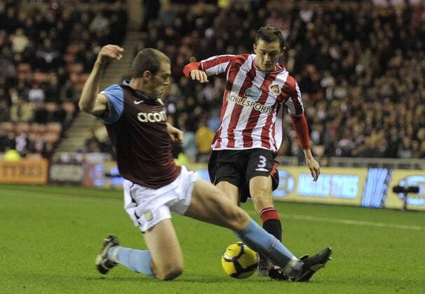 FC Sunderland s George McCartney (r.) and Aston Villa s Richard Dunne. Barclays Premier League Sunderland v Aston Villa 15th December, 2009 EDITORIAL USE ONLY. No use with unauthorised audio, video, data, fixture lists, club league logos or live services. Online in-match use limited to 120 images, no video emulation. No use in betting, games or single club league player publications. o0 McCartney