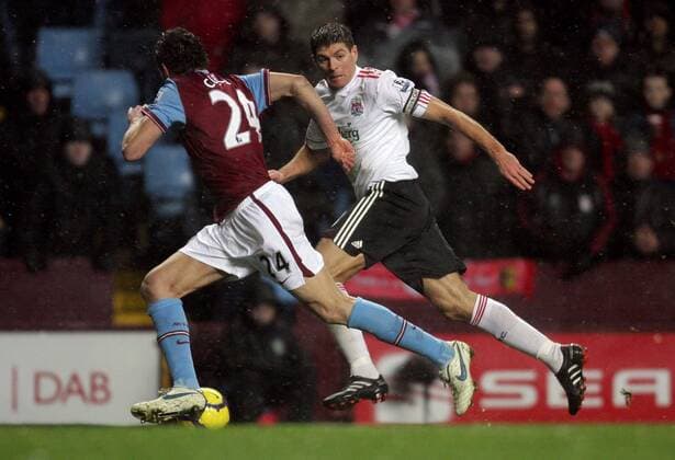 Steven Gerrard (R) of Liverpool FC competes with Carlos Cuellar of Aston Villa (l) Barclays Premier League Aston Villa v Liverpool 29th December, 2009 EDITORIAL USE ONLY. No use with unauthorised audio, video, data, fixture lists, club league logos or live services. Online in-match use limited to 120 images, no video emulation. No use in betting, games or single club league player publications. o00 Birmingham