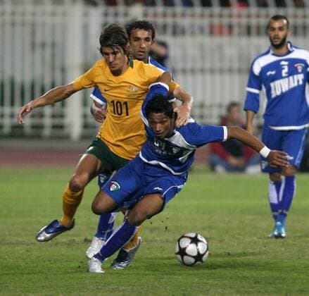 KUWAIT CITY - Dario Vidosic (L) of Australia vies for ball with Yousuf Al Sulaiman of Kuwait during their AFC Asian Cup Group B qualification round match at Kuwait Sports Club Stadium in Kuwait City, January 6, 2010. The match ended with a draw of 2-2. - 