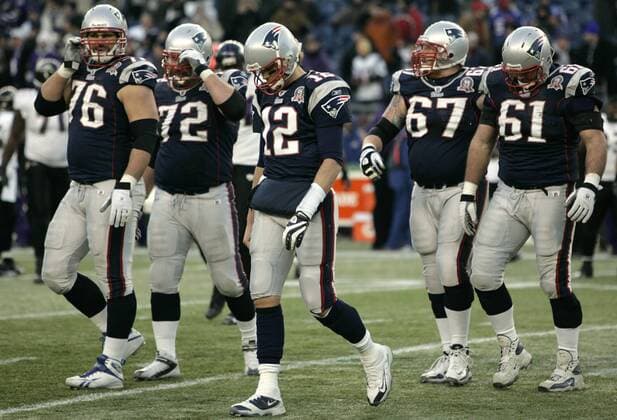 New England Patriots quarterback Tom Brady (12) walks off the field with his offensive line in the last seconds of the AFC Wildcard game against the Baltimore Ravens at Gillette Stadium in Foxboro, Massachusetts on January 10, 2010. The Ravens defeated the Patriots 33-14.  BOS2010011028
