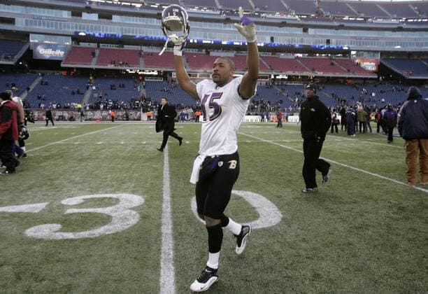 Baltimore Ravens wide receiver Kelley Washington (15) points to the remaining fans after the AFC Wildcard game against the New England Patriots at Gillette Stadium in Foxboro, Massachusetts on January 10, 2010. The Ravens defeated the Patriots 33-14.  BOS2010011016