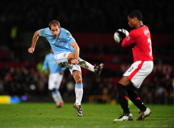 Pablo Zabaleta (L) of Manchester City takes a shot on goal - Carling Cup, Semi Final 2nd Leg, Manchester United - Manchester City, 27th January, 2010 - EDITORIAL USE ONLY. No use with unauthorised audio, video, data, fixture lists, club league logos or live services. Online in-match use limited to 120 images, no video emulation. No use in betting, games or single club league player publications.