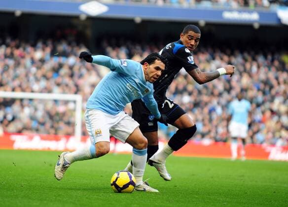 Carlos Tevez (L) of Manchester City and Kevin-Prince Boateng of Portsmouth Barclays Premier League Manchester City v FC Portsmouth 31st January, 2010 EDITORIAL USE ONLY. No use with unauthorised audio, video, data, fixture lists, club league logos or live services. Online in-match use limited to 120 images, no video emulation. No use in betting, games or single club league player publications.