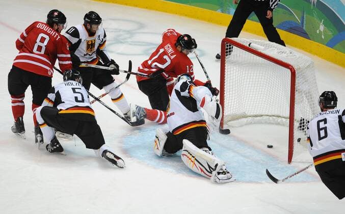 Canada s Jarome Iginla (4.L) puts the puck past Germany s Thomas Greiss (2.R) during the second period at Canada Hockey Place in Vancouver, Canada, during the 2010 Winter Olympics on February 23, 2010. -  OLY2010022396 o0 Tor