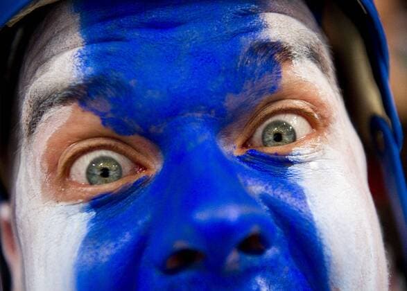 Feb 24, 2010 - Vancouver, - Face painted Finnish fan HEIKKI MELLA-AHO of , Finland cheers for his home team . - ZUMAf72 o0 Jubel Freude Gesichtsbemalung, Nationalfarben Fan, Zuschauer Detail Mimik Auge kurios