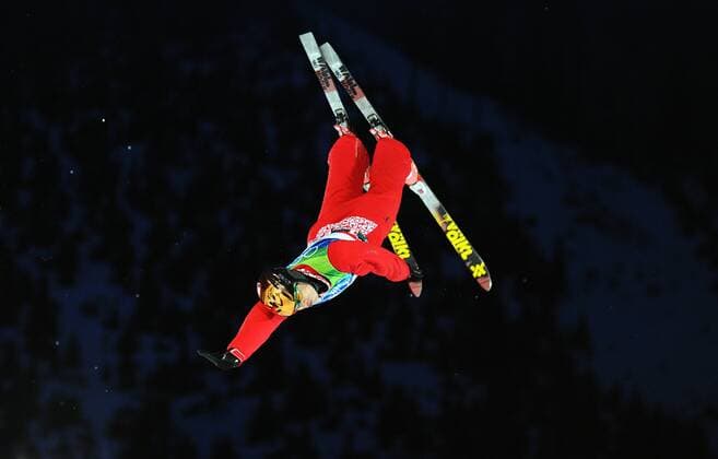 China s Liu Zhongqi acts during the men s aerials final of Freestyle Skiing at the 2010 Winter Olympic Games in Cypress Mountain, Canada, Feb. 25, 2010. 