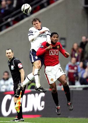 Stephen Warnock of Aston Villa and Luis Antonio Valencia of Manchester United leap for the ball - Carling Cup Final, Aston Villa (white) vs. Manchester United (red) 28th February, 2010 EDITORIAL USE ONLY. No use with unauthorised audio, video, data, fixture lists, club league logos or live services. Online in-match use limited to 120 images, no video emulation. No use in betting, games or single club league player publications. o0 Manu