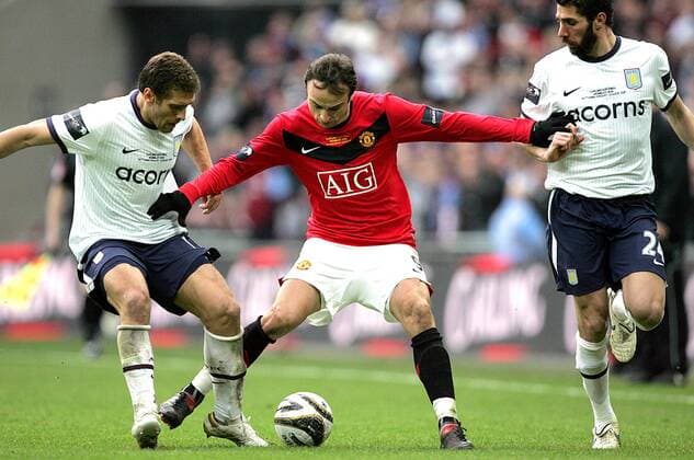 Dimitar Berbatov of Manchester United holds off Stiliyan Petrov of Aston Villa - Carling Cup Final, Aston Villa (white) vs. Manchester United (red) 28th February, 2010 EDITORIAL USE ONLY. No use with unauthorised audio, video, data, fixture lists, club league logos or live services. Online in-match use limited to 120 images, no video emulation. No use in betting, games or single club league player publications. o0 Ligapokal Manu