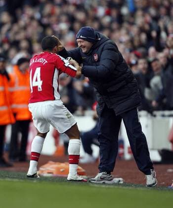Arsenal s Theo Walcott (L) celebrates scoring his sides second goal with backroom staff and a watch Barclays Premier League Arsenal FC vs. Burnley FC 6th March, 2010 EDITORIAL USE ONLY. No use with unauthorised audio, video, data, fixture lists, club league logos or live services. Online in-match use limited to 120 images, no video emulation. No use in betting, games or single club league player publications. o0 Jubel, Freude,