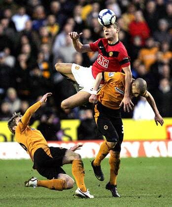 Nemanja Vidic of Manchester United (C) and Adiene Guedioura of Wolverhampton Wanderers leap for the ball Barclays Premier League Wolverhampton Wanderers v Manchester United 6th March, 2010 EDITORIAL USE ONLY. No use with unauthorised audio, video, data, fixture lists, club league logos or live services. Online in-match use limited to 120 images, no video emulation. No use in betting, games or single club league player publications.