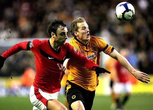Dimitar Berbatov of Manchester United (L) and Christophe Berra of Wolverhampton Wanderers chase the ball Barclays Premier League Wolverhampton Wanderers v Manchester United 6th March, 2010 EDITORIAL USE ONLY. No use with unauthorised audio, video, data, fixture lists, club league logos or live services. Online in-match use limited to 120 images, no video emulation. No use in betting, games or single club league player publications.