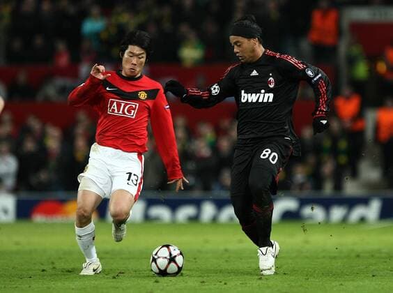 Manchester United v AC Milan, Old Trafford, Manchester UEFA Champions League 10 03 2010 Milan s Ronaldinho (R) comes under pressure from Park Ji-Sung of Manchester United 