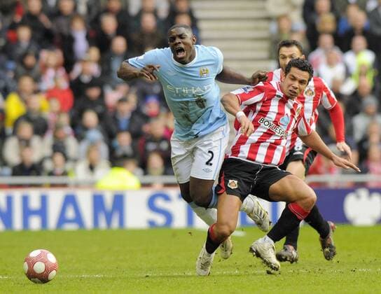 Sunderland AFC s Kieran Richardson (R) catches Manchester City s Micah Richards . Barclays Premier League Sunderland AFC v Manchester City 14th March, 2010 EDITORIAL USE ONLY. No use with unauthorised audio, video, data, fixture lists, club league logos or live services. Online in-match use limited to 120 images, no video emulation. No use in betting, games or single club league player publications.
