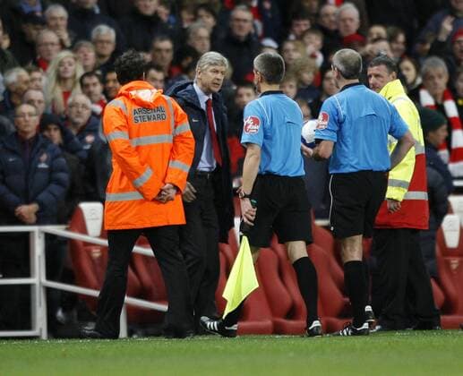 Arsenal s coach Arsene Wenger argues with referee Martin Atkinson at half time Barclays Premier League FC Arsenal v West Ham United 20th March, 2010 EDITORIAL USE ONLY. No use with unauthorised audio, video, data, fixture lists, club league logos or live services. Online in-match use limited to 120 images, no video emulation. No use in betting, games or single club league player publications.