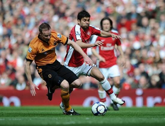 Premier League - Arsenal FC London - Wolverhampton Wanderers 1:0 - Jody Craddock of Wolverhampton Wanderers (L) and Arsenal s Eduardo da Silva challenge for the ball at the Emirates Stadium in London 