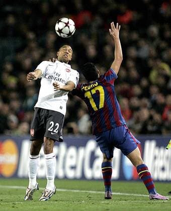 Gael Clichy of Arsenal FC (white) and Pedro of Barcelona FC (red) leap for the ball UEFA Champions League quarterfinal 2nd leg Barcelona v Arsenal FC (white) 6th April, 2010 EDITORIAL USE ONLY. No use with unauthorised audio, video, data, fixture lists, club league logos or live services. Online in-match use limited to 120 images, no video emulation. No use in betting, games or single club league player publications.