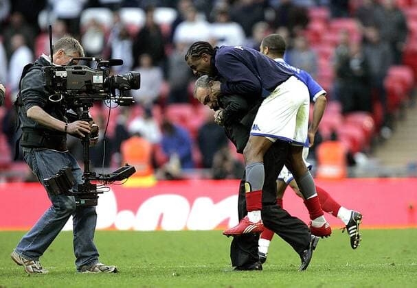 coach Avram Grant of Portsmouth FC celebrates at the ending whistle with Frederic Piquionne - FA Cup Semifinal Tottenham Hotspur (white) v Portsmouth FC (blue) 11th April, EDITORIAL USE ONLY. No use with unauthorised audio, video, data, fixture lists, club league logos or live services. Online in-match use limited to 120 images, no video emulation. No use in betting, games or single club league player publications. o0 Jubel Freude