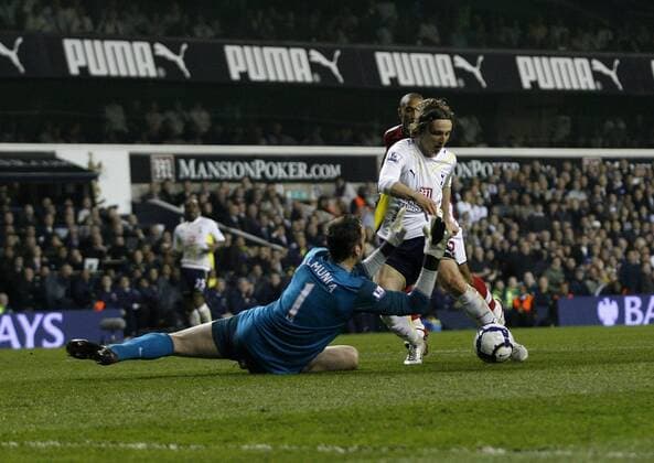 Tottenham s Luka Modric sees his shot saved by Arsenal s Manuel Almunia Barclays Premier League Tottenham Hotspur (white) vs Arsenal London (red) 14th April, 2010 EDITORIAL USE ONLY. No use with unauthorised audio, video, data, fixture lists, club league logos or live services. Online in-match use limited to 120 images, no video emulation. No use in betting, games or single club league player publications.