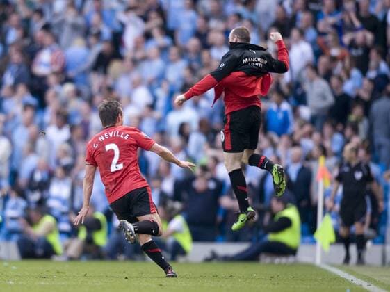 Wayne Rooney (R) of Manchester United comes off the bench to celebrate the winning goal along with Gary Neville of Manchester United Barclays Premier League - Manchester City vs. Manchester United (ManU) 17th April, 2010 EDITORIAL USE ONLY. No use with unauthorised audio, video, data, fixture lists, club league logos or live services. Online in-match use limited to 120 images, no video emulation. No use in betting, games or single club league player publications.