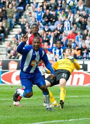 Titus Bramble (L) of Wigan Athletic turns to celebrate scoring the equalising goal Barclays Premier League Wigan Athletic vs Arsenal FC London 18th April, 2010 EDITORIAL USE ONLY. No use with unauthorised audio, video, data, fixture lists, club league logos or live services. Online in-match use limited to 120 images, no video emulation. No use in betting, games or single club league player publications.