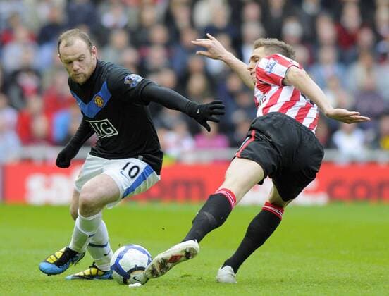 Sunderland s Matthew Kilgallon and ManU s Wayne Rooney, Sunderland AFC (red) - Manchester United (black), EDITORIAL USE ONLY. No use with unauthorised audio, video, data, fixture lists, club league logos or live services. Online in-match use limited to 120 images, no video emulation. No use in betting, games or single club league player publications.