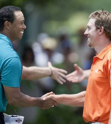 Tiger Woods (USA, L) congratulates Hunter Mahan (USA) after the second round of The Players Championship PGA golf tournament in Ponte Vedra Beach, Florida May 7, 2010.  PVB2010050718