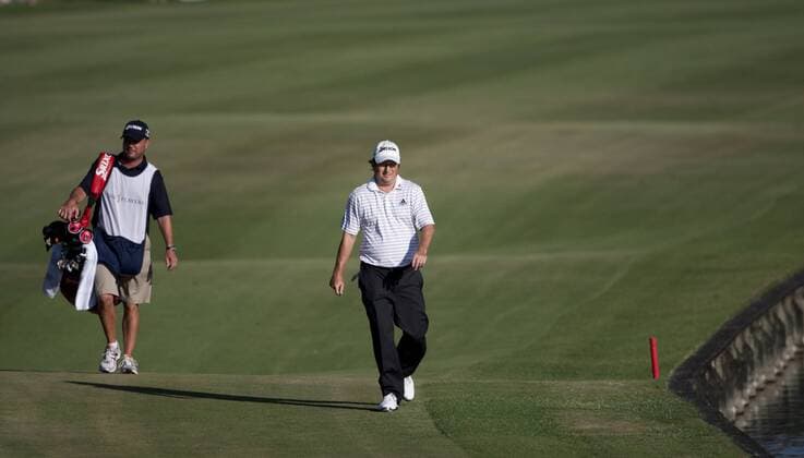 Tim Clark r. RSA and his caddie Steve Underwood walk up the 18th fairway during the final round of The Players Championship PGA golf tournament in Ponte Vedra Beach, Florida May 9, 2010.  PVB2010050920