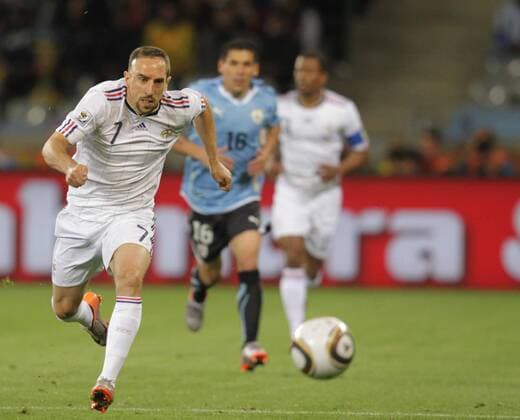 French Franck Ribery (L) breaks through during a Group match of the 2010 FIFA World Cup against Uruguay in Cape Town, on June 11, 2010. - France (white) vs Uruguay - 