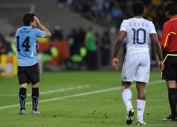 Nicolas Lodeiro (L) of Uruguay leaves the pitch after being given the red card during a Group match of the 2010 FIFA World Cup between Uruguay and France in Cape Town, on June 11, 2010. The match ended with a 0-0 draw. - France (white) vs Uruguay - 