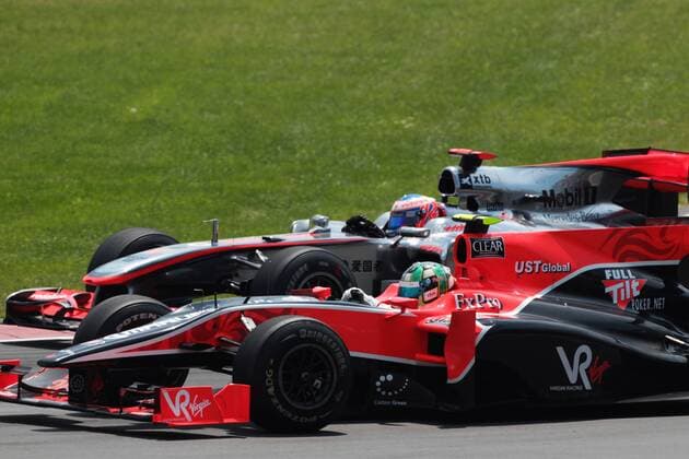 June 13, 2010 - Montreal, Canada - Jenson Button (GBR, back) McLaren MP4 25 passes Lucas di Grassi (BRA) Virgin Racing VR-01...Formula One World Championship, Rd 8, Canadian Grand Prix, Race Day.  - ZUMAorl
