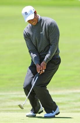 Tiger Woods (USA) winces after putting on the first green in the first round of the U.S. Open in Pebble Beach, California on June 17, 2010.  PBP2010061710