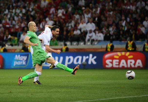 Football - 2010 FIFA World Cup - England vs. Algeria England s Frank Lampard (R) and Hassan Yebda of Algeria at Green Point Stadium, Cape Town 