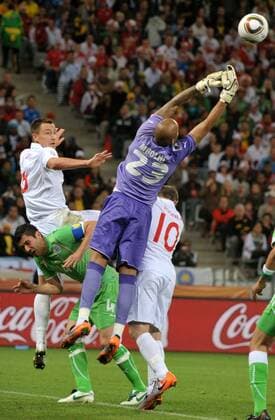 Algeria s Rais M Bolhi (R) tries to save the ball against John Terry (L) and Wayne Rooney (R) of England and Anther Yahia of Algeria during the 2010 World Cup Group C match against England in Cape Town  o0 Mbolhi