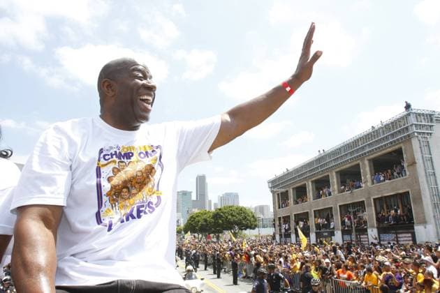 Magic Johnson waves to fans as the Los Angeles Lakers celebrate their NBA championship with a parade in Los Angeles on June 21, 2010. The Lakers defeated Celtics to win the championship .  LAP201006214013