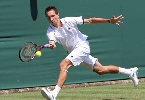 Ukrainian Sergiy Stakhovsky plays a forehand in his match on the second day of the Wimbledon championships in Wimbledon on Tuesday June 22 2010.  LON2010062202