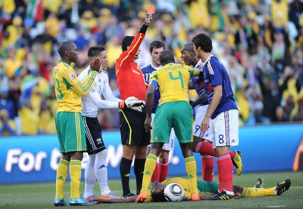 Referee Oscar Ruiz (3rd L) of Colombia shows the red card to France s Yoann Gourcuff (1st R) during a Group A match between France and South Africa at the 2010 World Cup football match in Bloemfontein - 