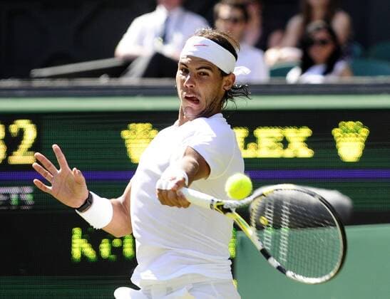 LONDON, June 23, 2010 -- Rafael Nadal of Spain returns a shot during his first round match of men s singles in the 2010 Wimbledon Championships in London, Britain, June 22, 2010. --- 