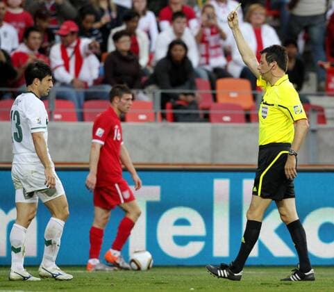 (100623) -- PORT ELIZABETH, June 23, 2010 () -- Slovenia s Bojan Jokic (L) is given a yellow card by Referee Wolfgang STARK (GER) during the 2010 World Cup Group C soccer match against England at Nelson Mandela Bay stadium in Port Elizabeth, June 23, 2010. - 