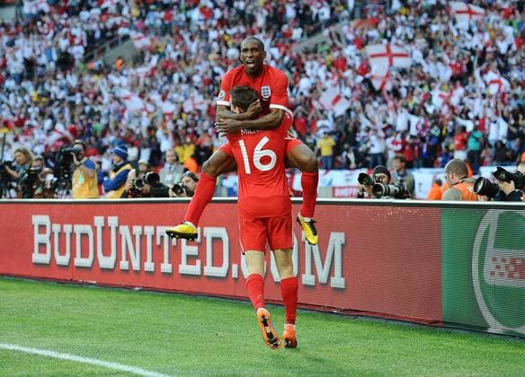 Football - 2010 FIFA World Cup - Slovenia vs. England England s Jermaine Defoe celebrates with James Milner scoring their opening goal at the Nelson Mandela Bay Stadium, Port Elizabeth 