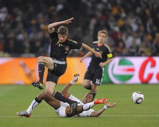 Thomas Mueller (L) of Germany tackled by Andre Ayew FIFA World Cup 2010 Group D Ghana v Germany 23rd June, 2010 EDITORIAL USE ONLY. No use with unauthorised audio, video, data, fixture lists, club league logos or live services. Online in-match use limited to 120 images, no video emulation. No use in betting, games or single club league player publications. Dede o0 DFB