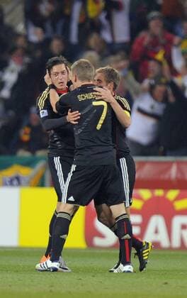 Mesut Oezil of Germany celebrates his goal with Bastian Schweinsteiger (C) and Philipp Lahm (R) - Group D, Ghana vs Germany - EDITORIAL USE ONLY. No use with unauthorised audio, video, data, fixture lists, club league logos or live services. Online in-match use limited to 120 images, no video emulation. No use in betting, games or single club league player publications.