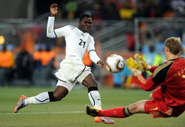 Ghana s Kwadwo Asamoah (L) kicks the ball against Manuel Neuer of Germany during the 2010 World Cup Group D match against Germany in Johannesburg 