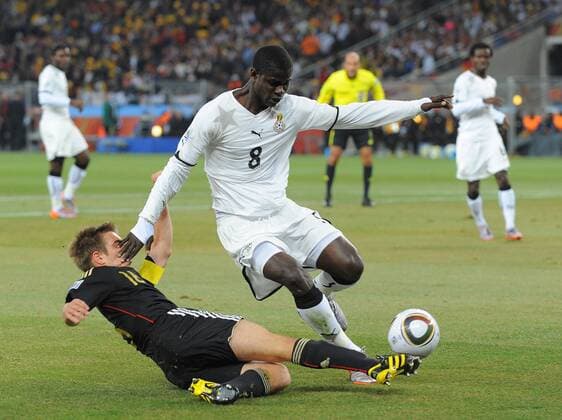 Philipp Lahm (L) of Germany gets in a cross past Jonathan Mensah of Ghana FIFA World Cup 2010 Group D Ghana v Germany 23rd June, 2010 EDITORIAL USE ONLY. No use with unauthorised audio, video, data, fixture lists, club league logos or live services. Online in-match use limited to 120 images, no video emulation. No use in betting, games or single club league player publications.