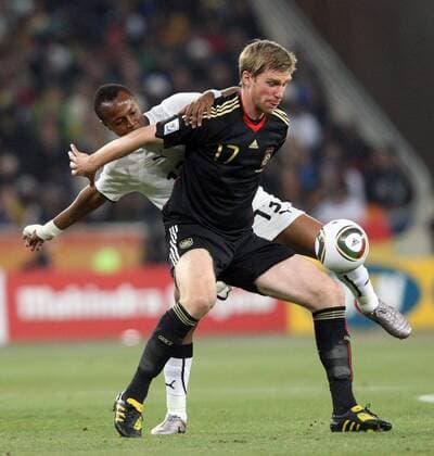 23 June 2010: Andre Ayew from Ghana and Per Mertesacker from Germany during the 2010 World Cup soccer game between Ghana (white) and Germany (black) on June 23, 2010 at Soccer City in Johannesburg Gallo0000117611 Dede