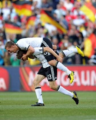 Lukas Podolski (top) of Germany celebrates the second goal with teammate Thomas Müller during the match between England and Germany at the 2010 FIFA World Cup at Free State stadium in Bloemfontein on June 27, 2010.  o0 Jubel Freude kurios Komik Emotionen