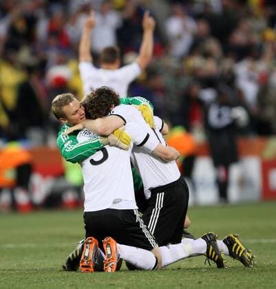 Germany s Manuel Neuer (L) celebrates his side fourth goal with Arne Friedrich (2L) - FIFA World Cup 2010 Round of 16 Germany v England (red) - 27th June, 2010 - EDITORIAL USE ONLY. No use with unauthorised audio, video, data, fixture lists, club league logos or live services. Online in-match use limited to 120 images, no video emulation. No use in betting, games or single club league player publications.