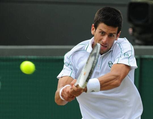 Serbia s Novak Djokovic returns a shot during the men s singles 4th round match at the 2010 Wimbledon Championships in London, Britain, June 30, 2010. 