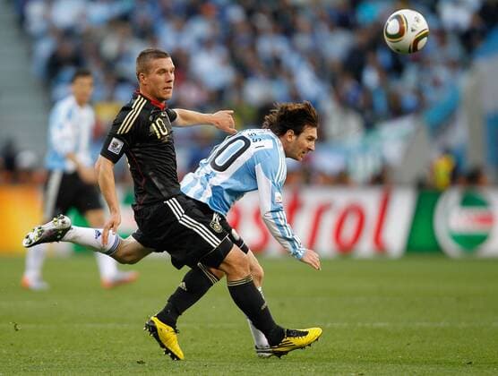 Lukas Podolski(L) of Germany vies with Lionel Messi of Argentina during the 2010 World Cup quarterfinal soccer match between Germany and Argentina in Cape Town on July 3,2010. 