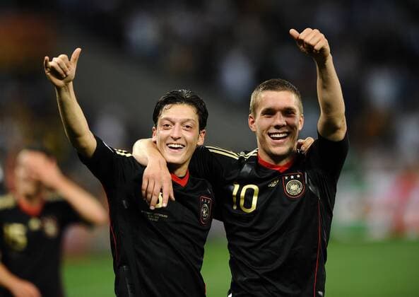 Football - 2010 FIFA World Cup - QuarterFinal - Argentina vs. Germany Mesut Ozil (L) and Lukas Podolski of Germany celebrate at Green Point Stadium, Cape Town 