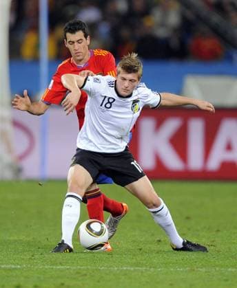 Toni Kroos r. of Germany and Sergio Busquets of Spain FIFA World Cup 2010 Semifinal Germany v Spain 7th July, 2010 EDITORIAL USE ONLY. No use with unauthorised audio, video, data, fixture lists, club league logos or live services. Online in-match use limited to 120 images, no video emulation. No use in betting, games or single club league player publications.